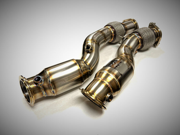 A top view of Evolution Racewerks Sports Series High Flow Catted Downpipes BMW X3M/X4M S58 Engine in Brushed Finish
