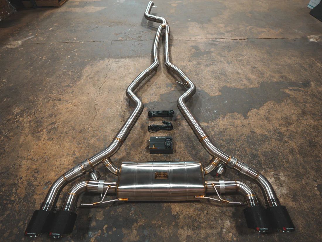 A top overview of Valvetronic Designs Valved Sport Exhaust System with 1x1 Carbon Fiber exhaust tips on the ground (for BMW G20/G22 M340i/M440i). 