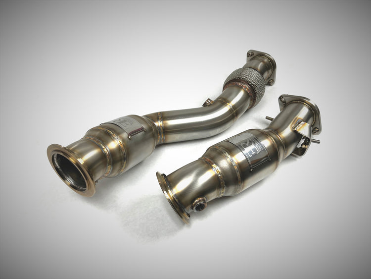 A top view of Evolution Racewerks High Flow Catted Downpipes BMW G80 M3/ G82 M4 2021 + in Brush Finish